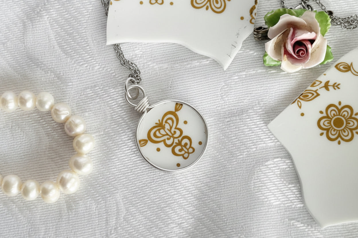 Necklace with a round pendant featuring a gold design on a white fabric background.