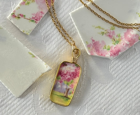 Necklace with a floral pendant on a textured surface