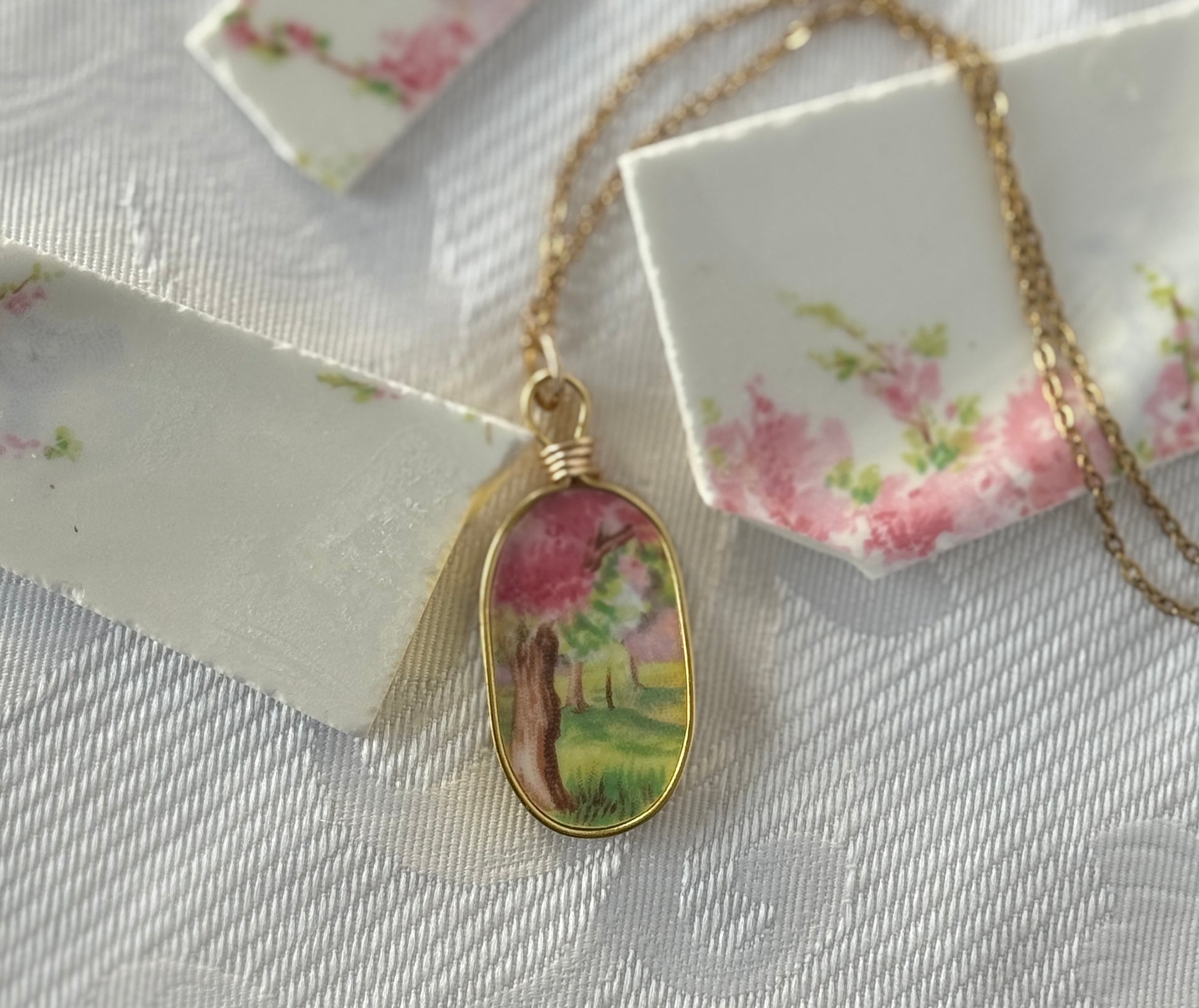 Necklace with a floral pendant on a textured surface