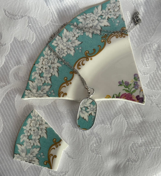 Necklace with a floral pendant on a decorative jewelry box