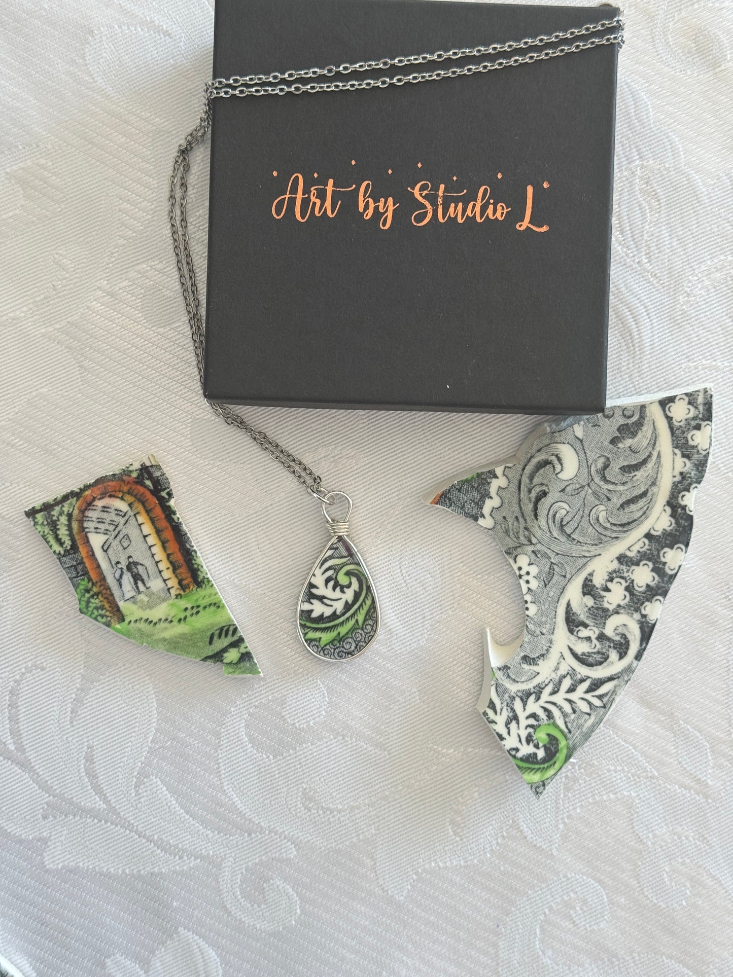 Decorative earrings with intricate patterns on a textured surface