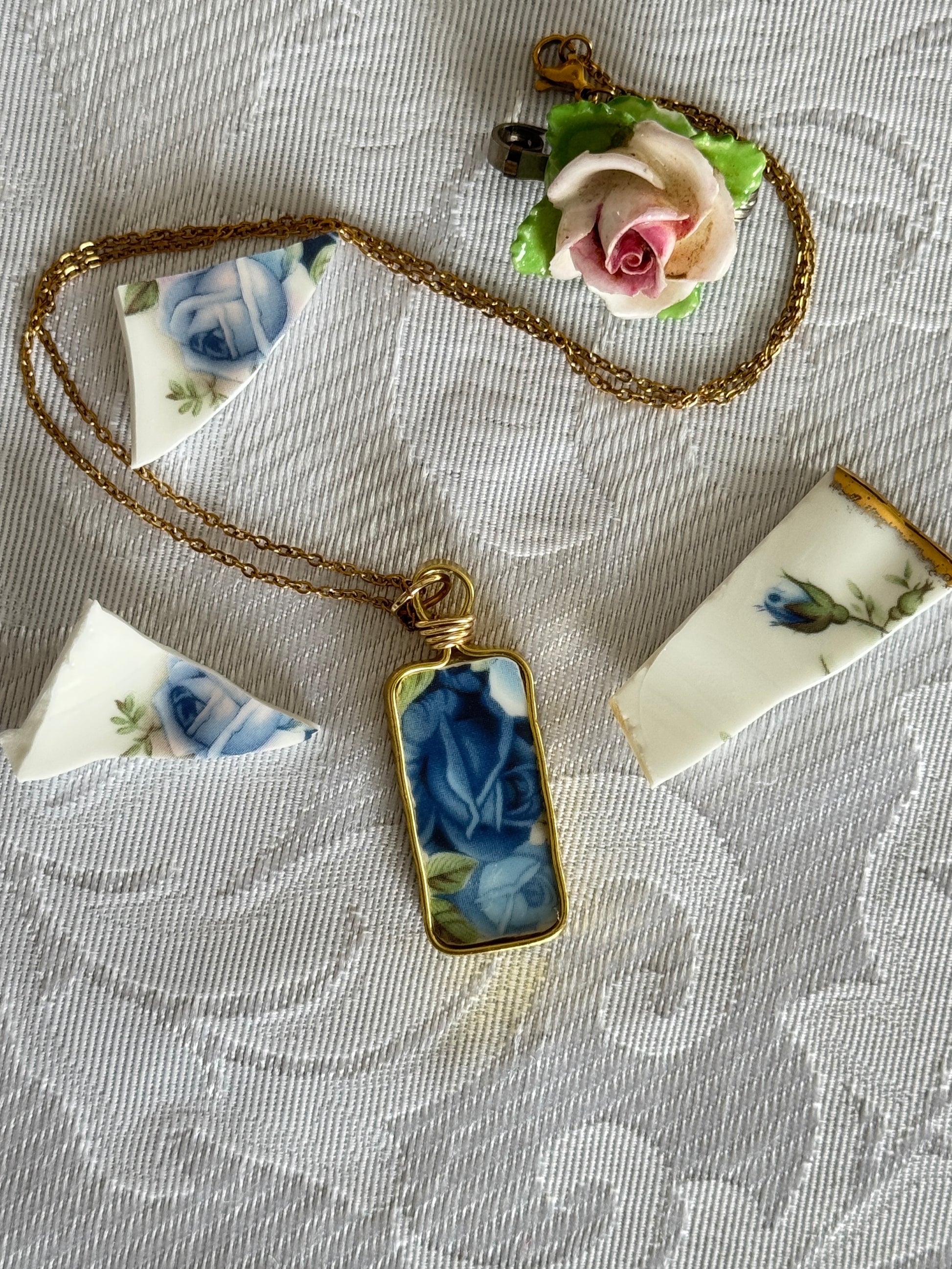 Necklace with a decorative pendant on a textured fabric background