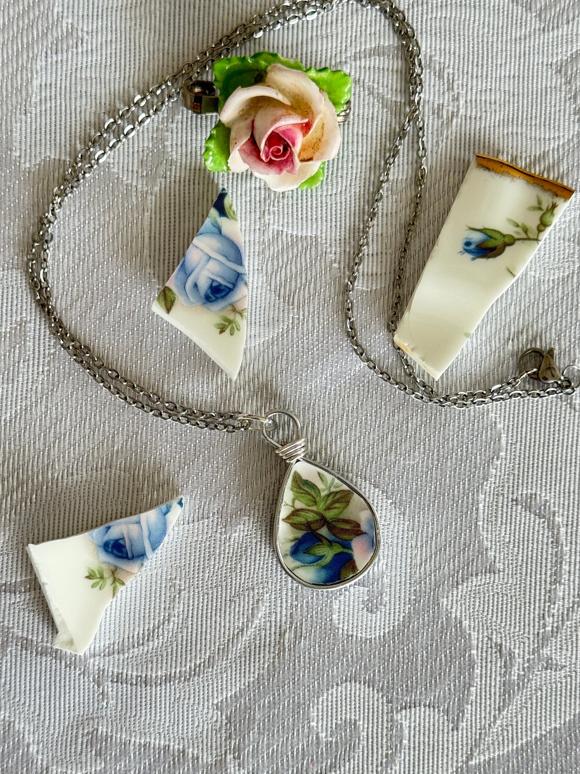teardrop pendant with blue rose and leaves