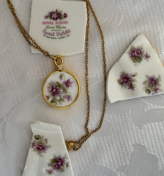 Necklace with floral pendant on a textured white fabric background