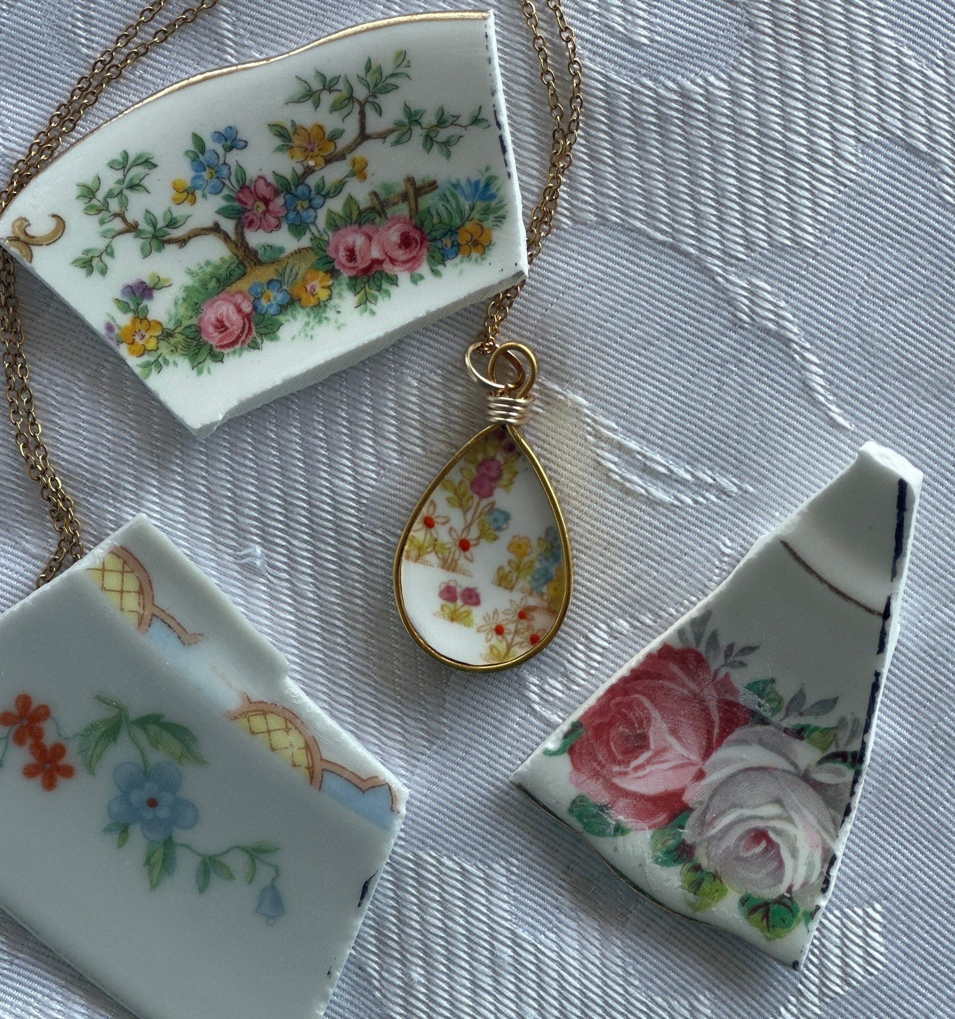 Decorative ceramic pieces with floral designs on a textured surface
