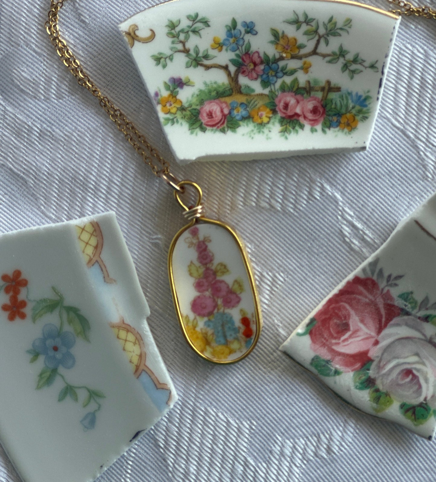 Decorative ceramic pieces with floral designs on a textured surface