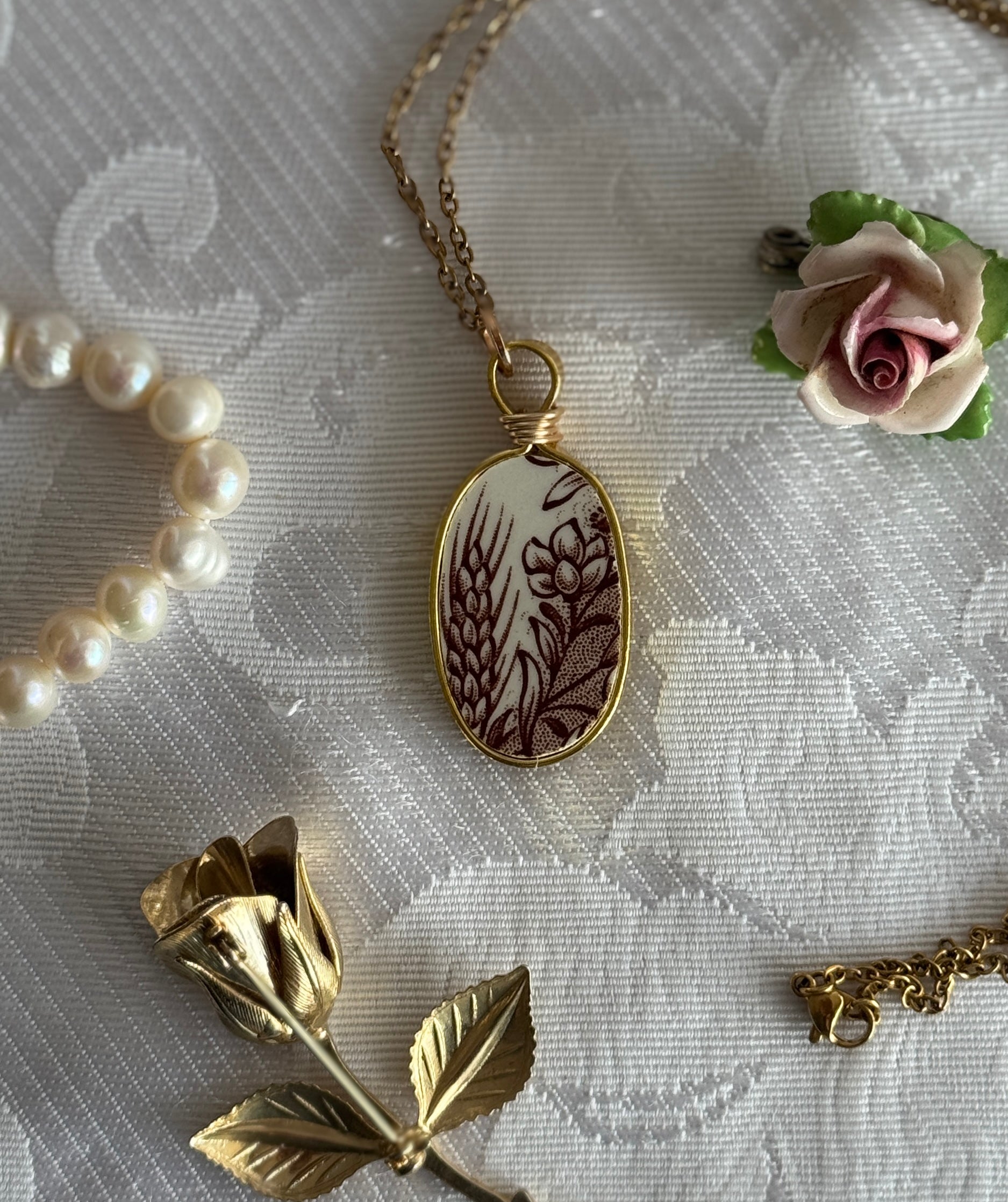 Necklace with a decorative pendant on a textured fabric background