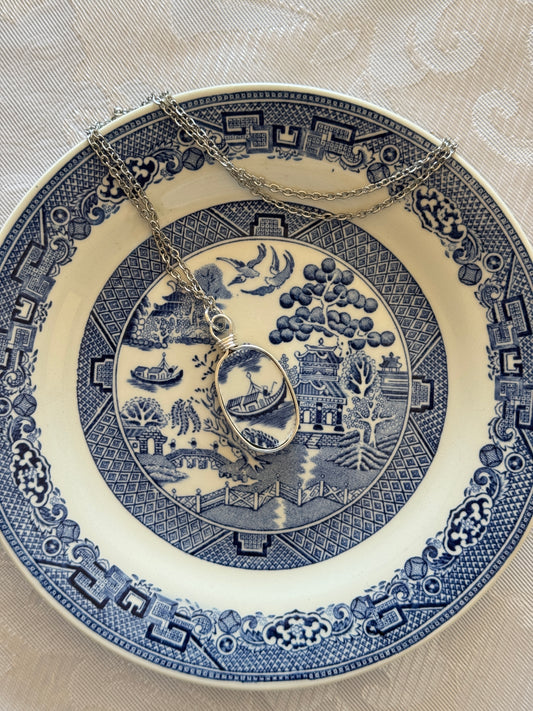 Decorative blue and white plate with intricate patterns on a beige background
