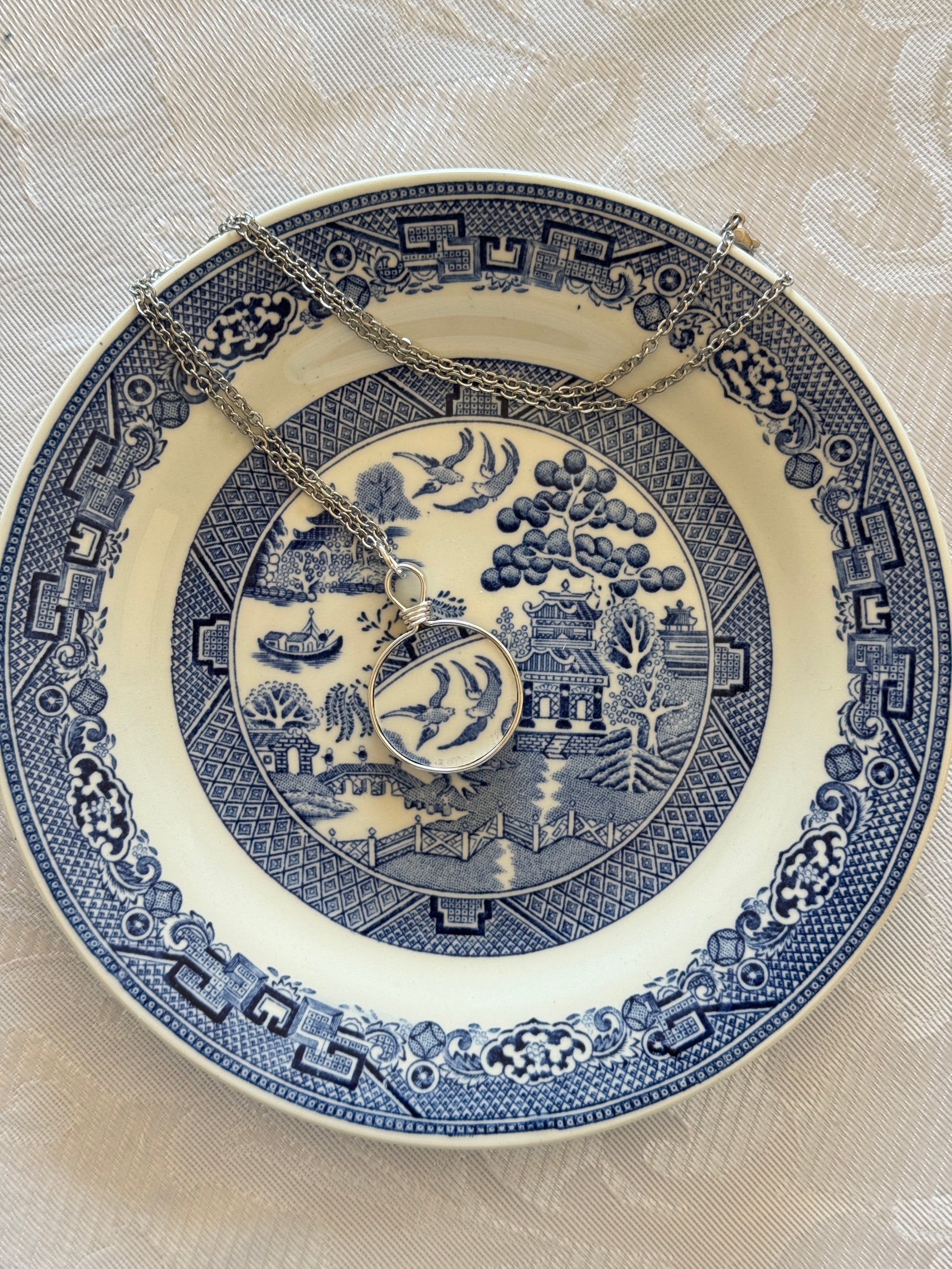 Blue and white decorative plate with intricate patterns on a beige background