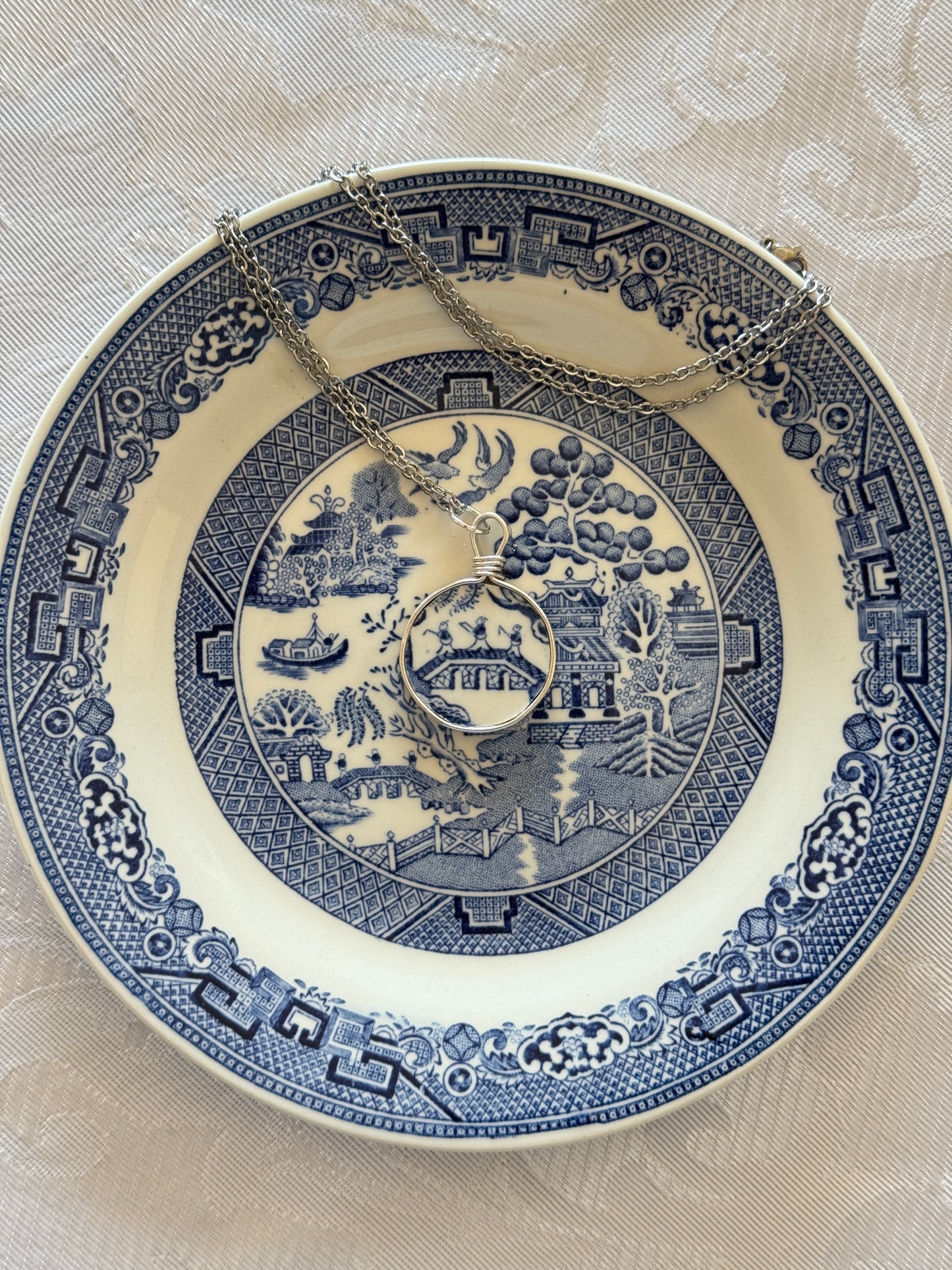Decorative blue and white plate with intricate patterns on a beige background