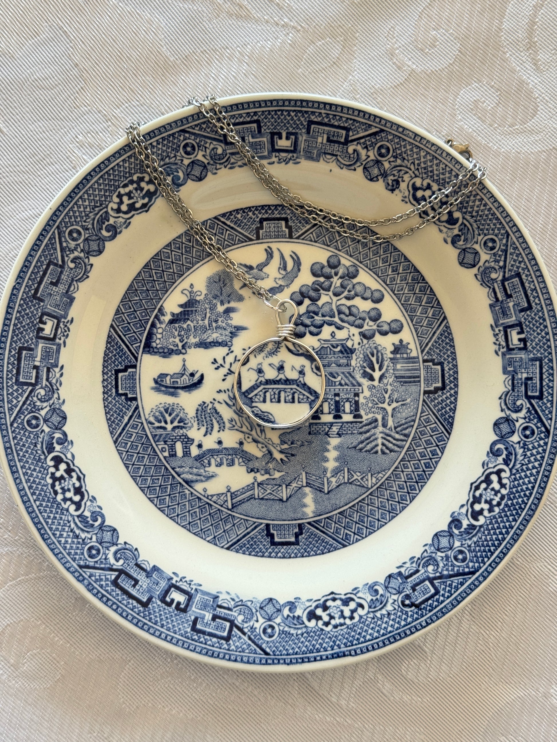 Decorative blue and white plate with intricate patterns on a beige background