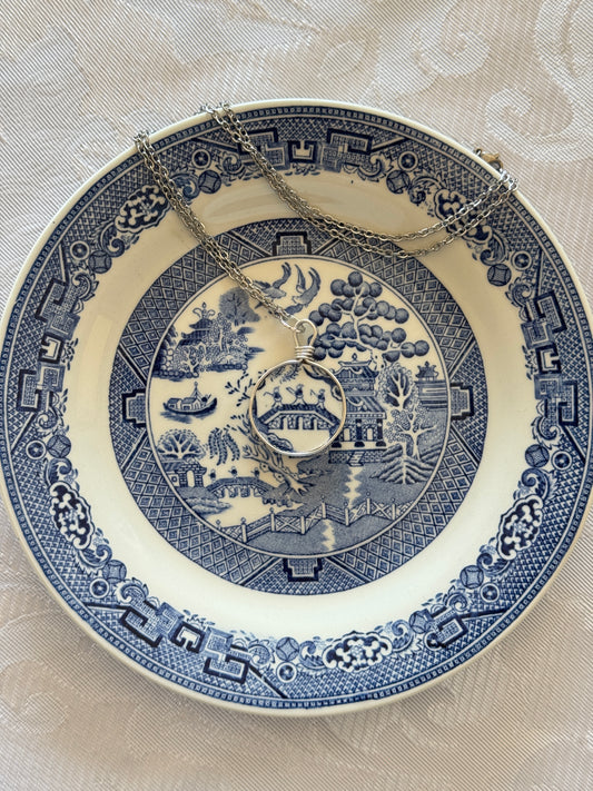 Decorative blue and white plate with intricate patterns on a beige background