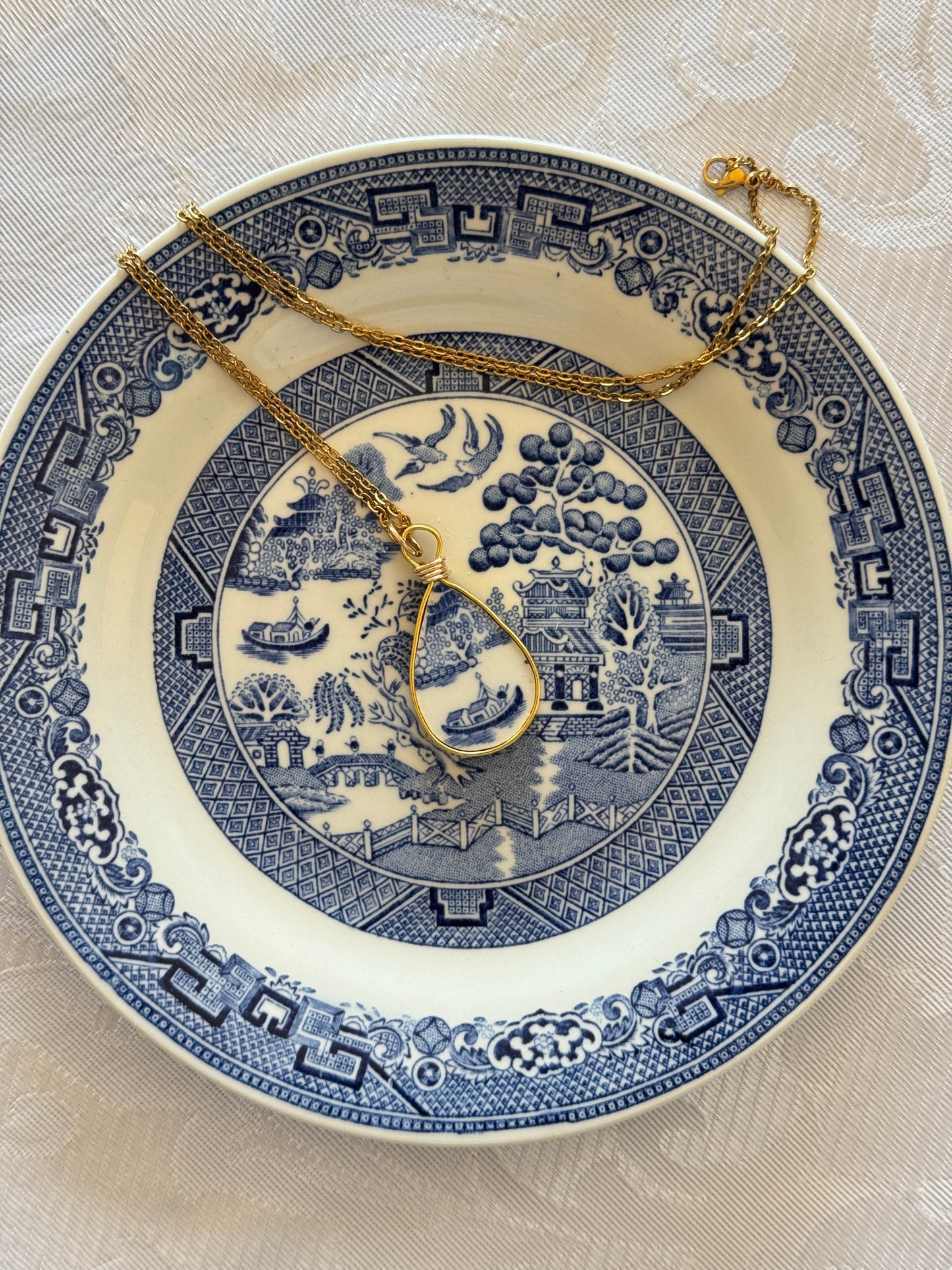 Decorative blue and white plate with intricate patterns on a beige background