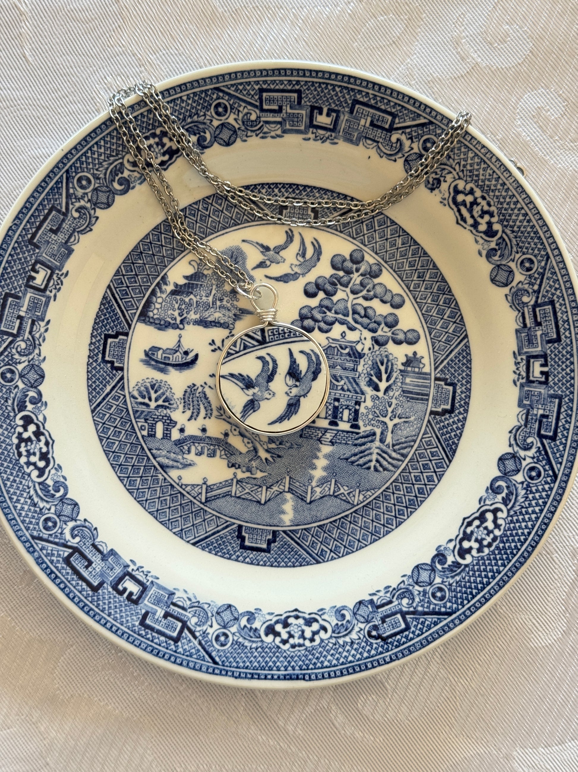 Decorative blue and white plate with intricate patterns on a beige background