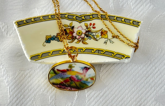 Necklace with a pendant featuring birds on a broken piece of China