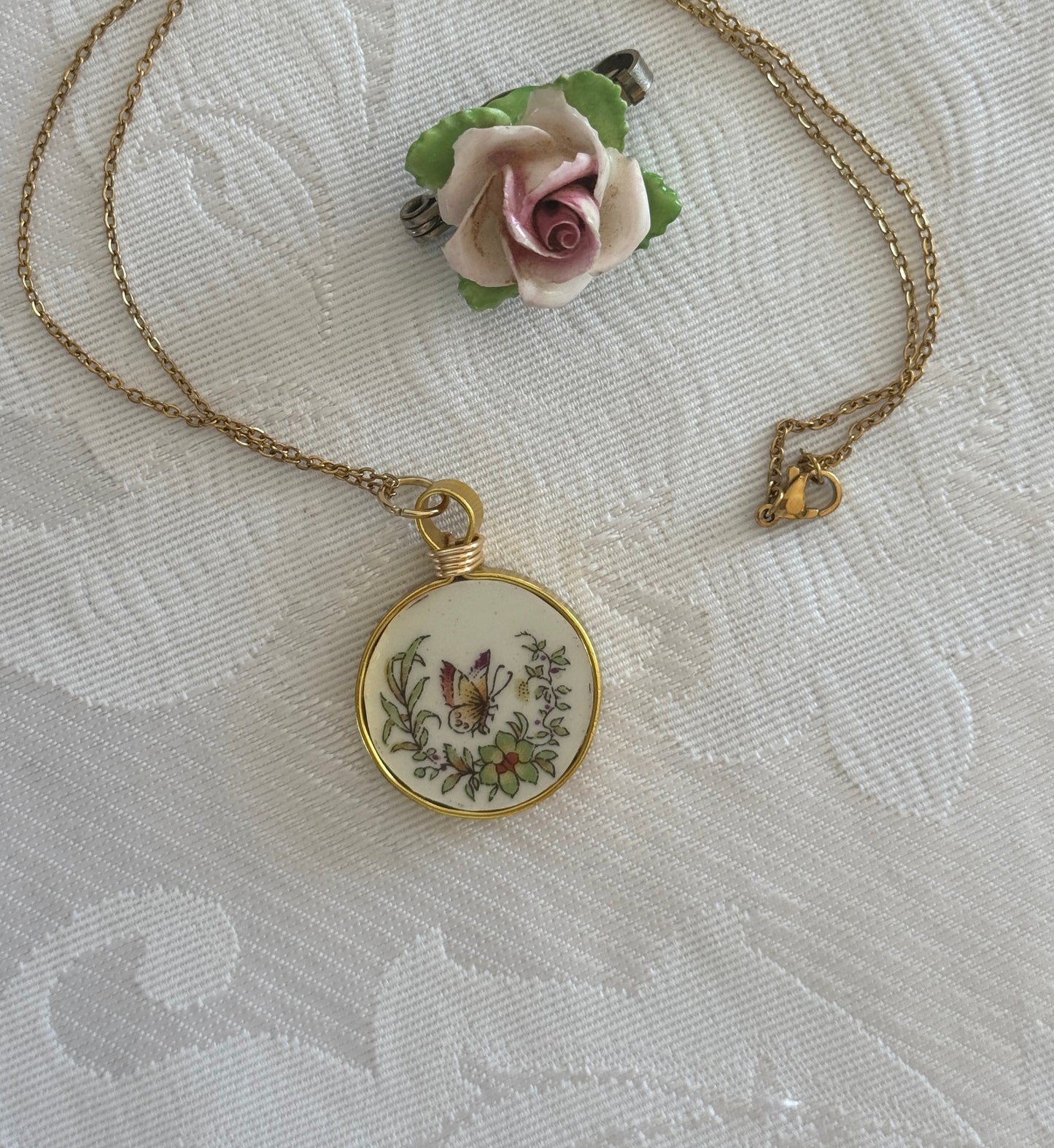 Decorative pendant with floral design on a textured fabric background