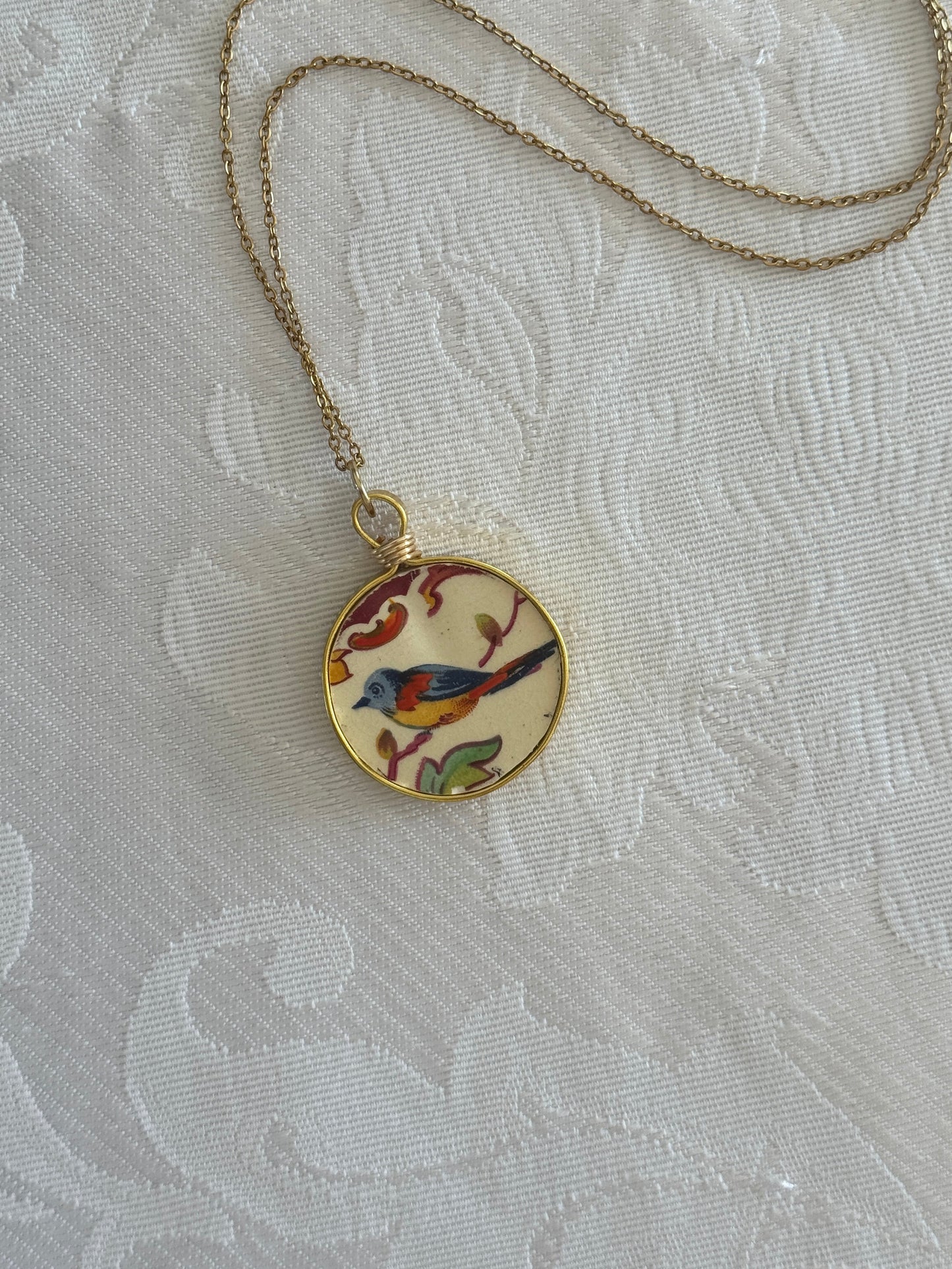 Necklace with a decorative pendant on a textured white background