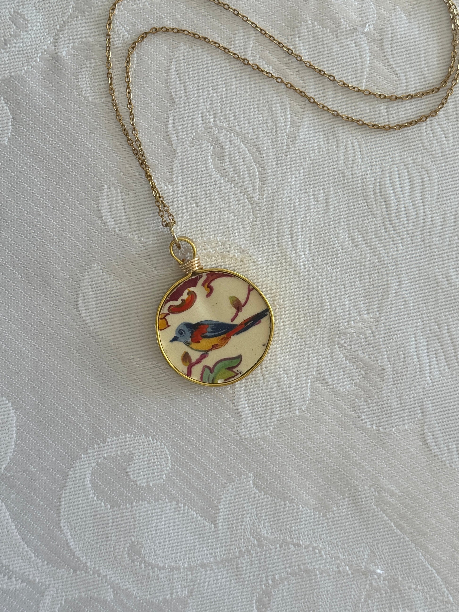 Necklace with a decorative pendant on a textured white background