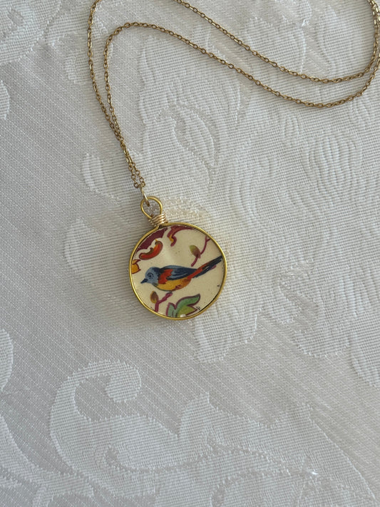 Necklace with a decorative pendant on a textured white background