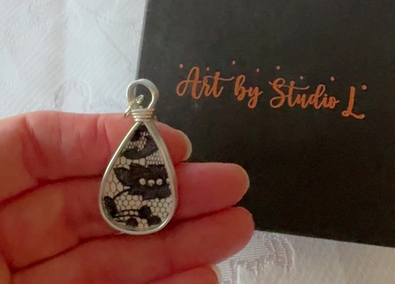 Blans and White design in a tear drop shaped pendant.